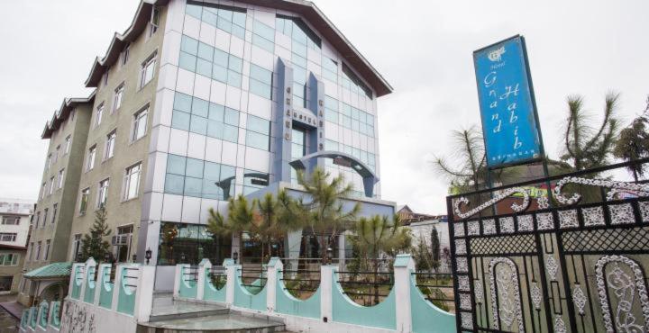 a building with a fence in front of it at Hotel Grand Habib in Srinagar