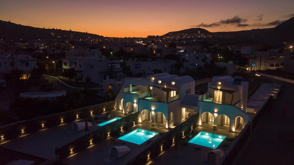 a view of a house at night with lights at Modern Dome Homes Of Santorini in Perissa