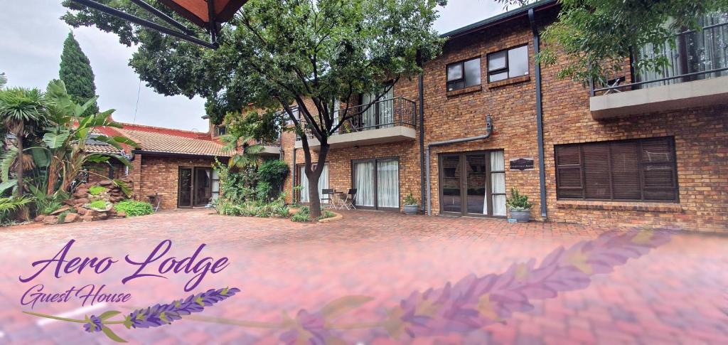 a house with a brick driveway in front of it at Aero Lodge Guest House in Middelburg