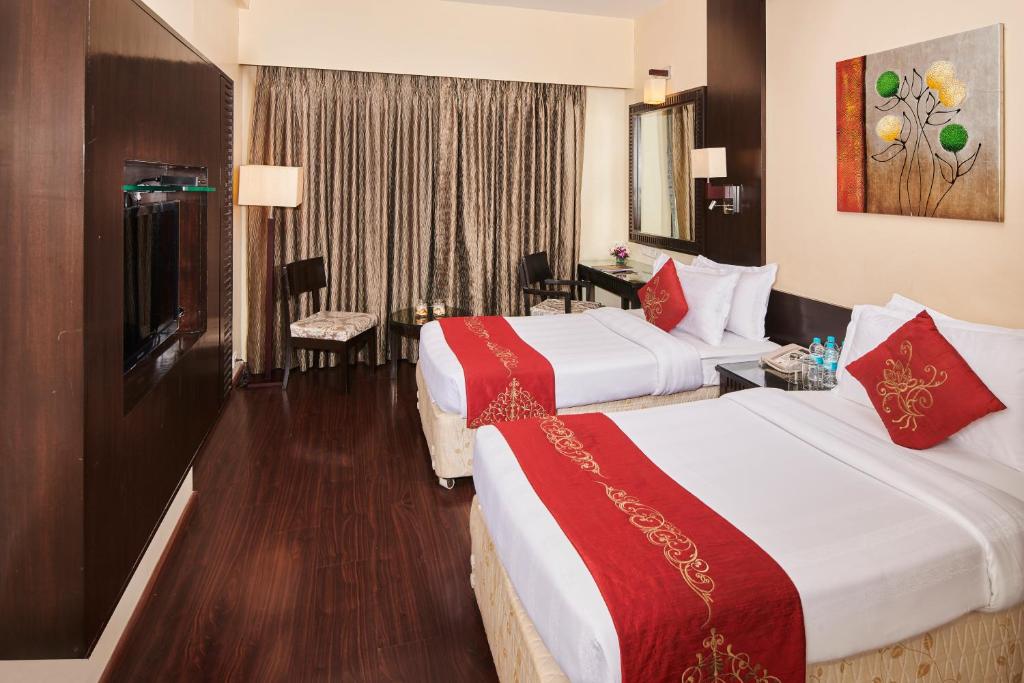 Postel nebo postele na pokoji v ubytování Goldfinch Hotel Mumbai