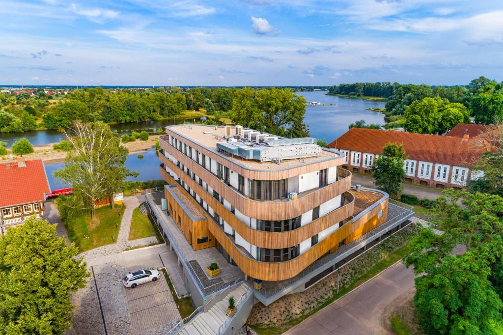 an overhead view of a building next to a river at Das ELB Boardinghouse Hotel Restaurant in Magdeburg