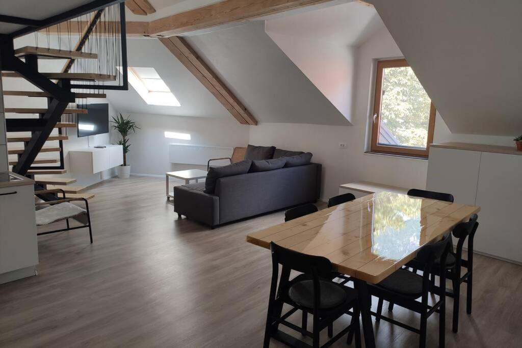 a living room with a table and a couch at Bovec Loft apartment in Bovec