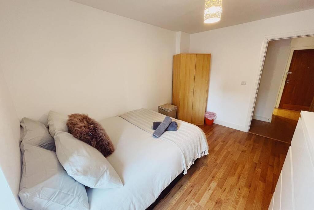 a bedroom with a white bed and a wooden floor at 1 Bedroom City Centre Apartment - Sleeps 4 Free Parking in Newcastle upon Tyne