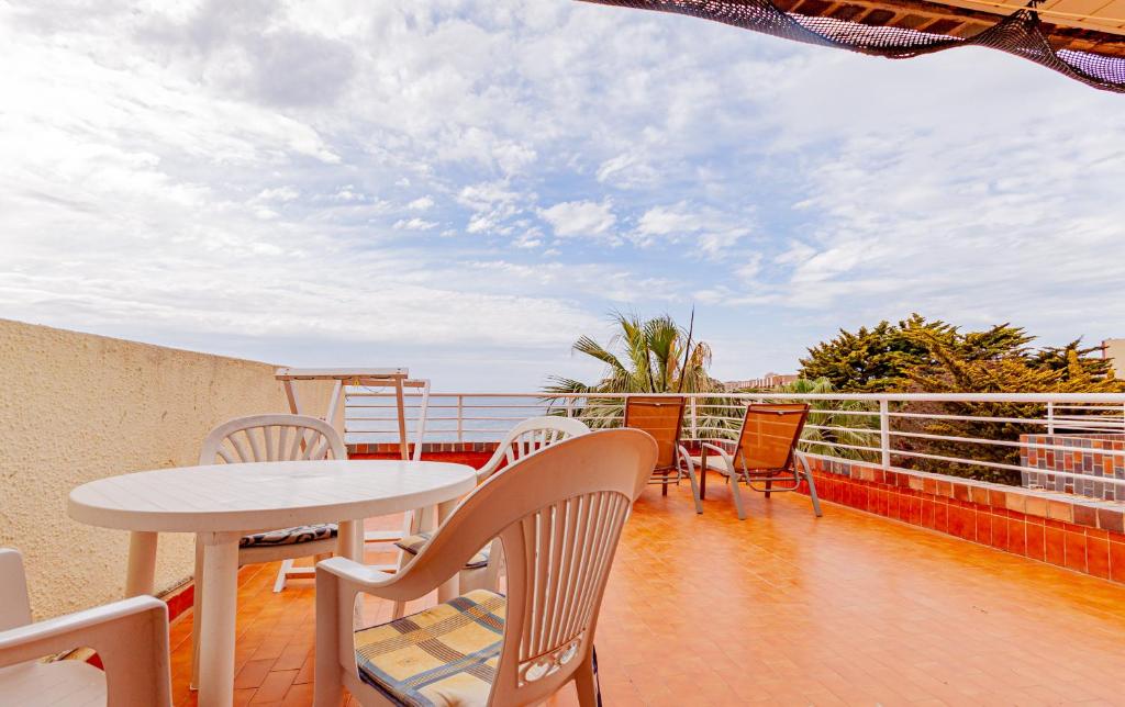 a balcony with a table and chairs and the ocean at Arpon 23c in La Manga del Mar Menor