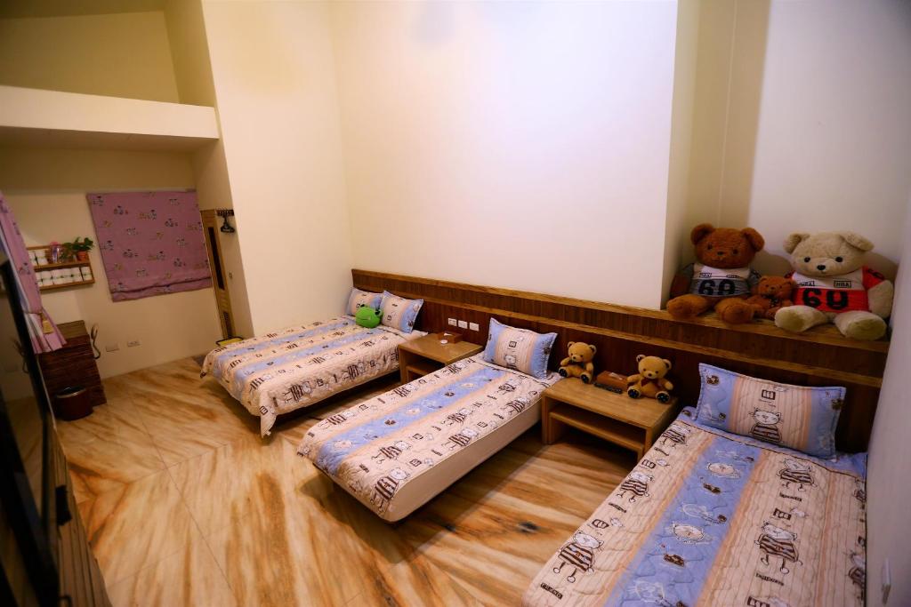 Postel nebo postele na pokoji v ubytování 鄉間雅築休閒民宿Country Villa Homestay