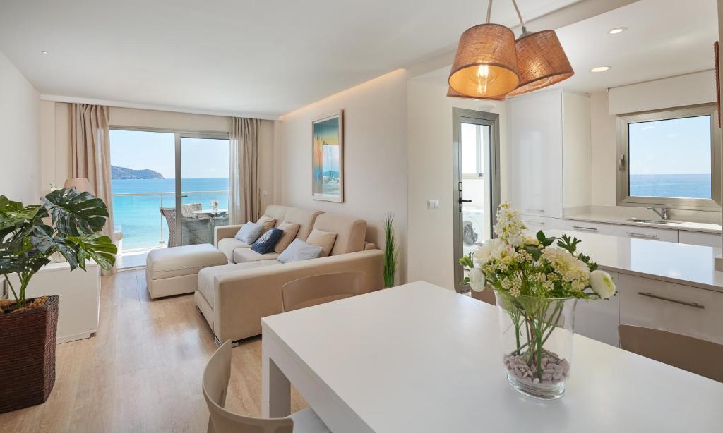 a living room with a couch and a table at SA MANIGA 6-H in Cala Millor