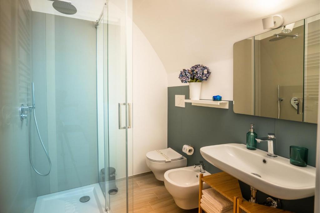 a bathroom with a toilet and a sink and a shower at Vico Blu in Polignano a Mare