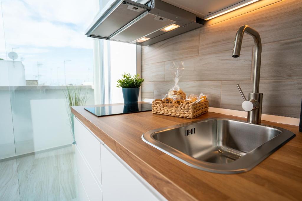 a kitchen with a stainless steel sink in a kitchen at Vico Blu in Polignano a Mare