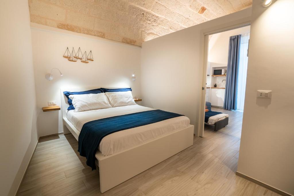 a bedroom with a king sized bed with blue sheets at Vico Blu in Polignano a Mare