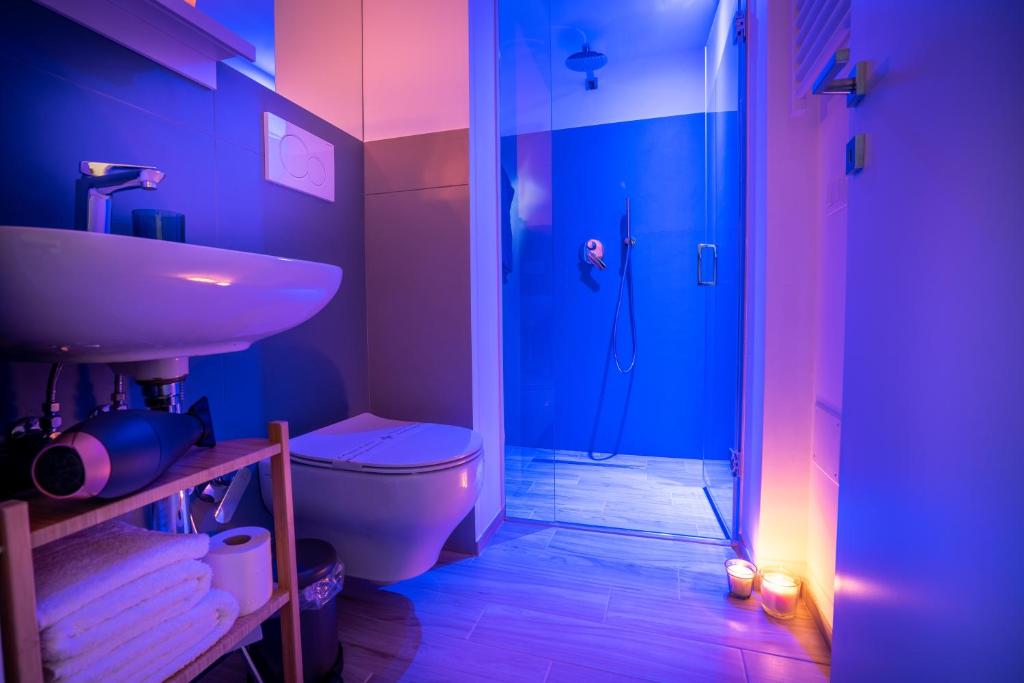 a bathroom with a toilet and a sink and a shower at Vico Blu in Polignano a Mare