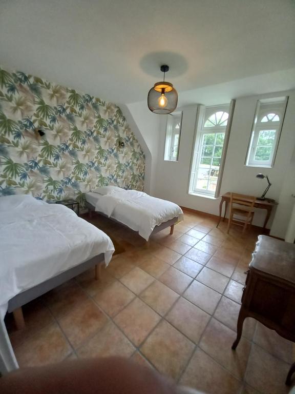 Postel nebo postele na pokoji v ubytování l'orangerie