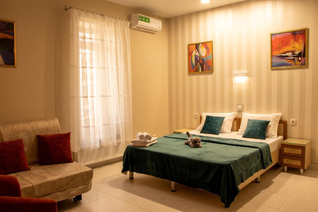 
a bedroom with a bed, chair, table and a lamp at Sana Hostel in Kharkiv
