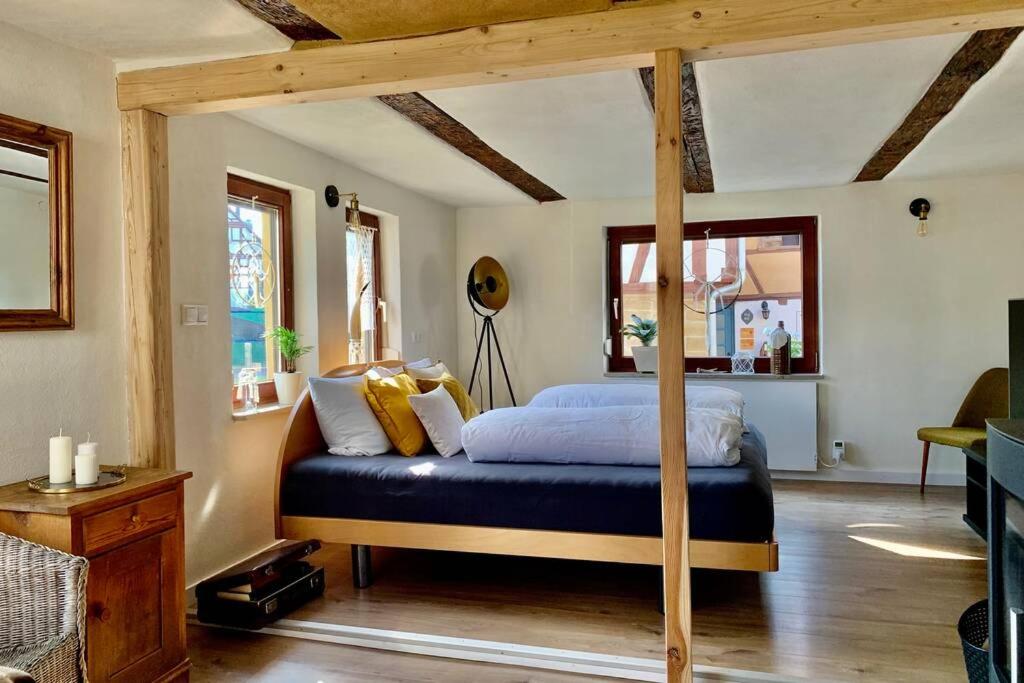 a bedroom with a canopy bed in a room at Haus Engelbert in Höchheim