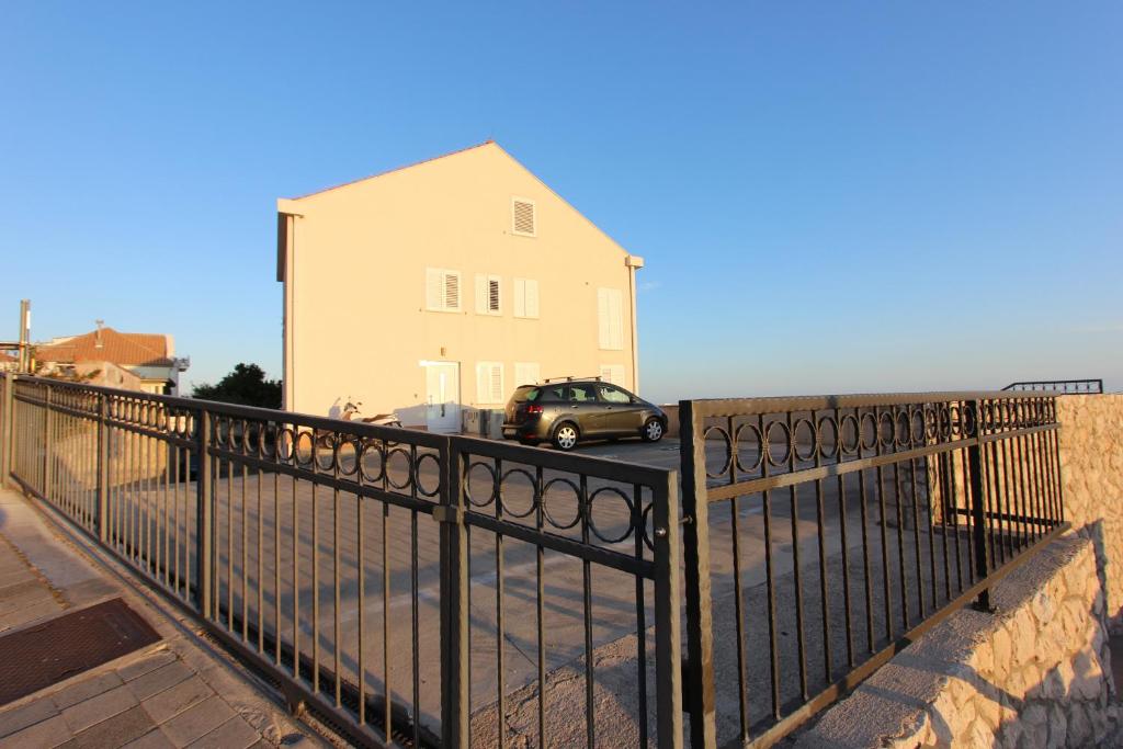 a black fence with a car in front of a building at Studio Talir in Dubrovnik