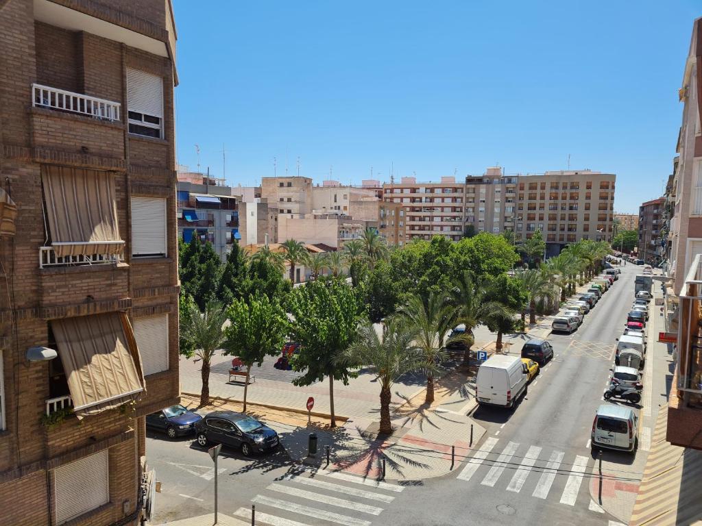 a view of a city street with cars parked at Enrique Número 68 in Elche