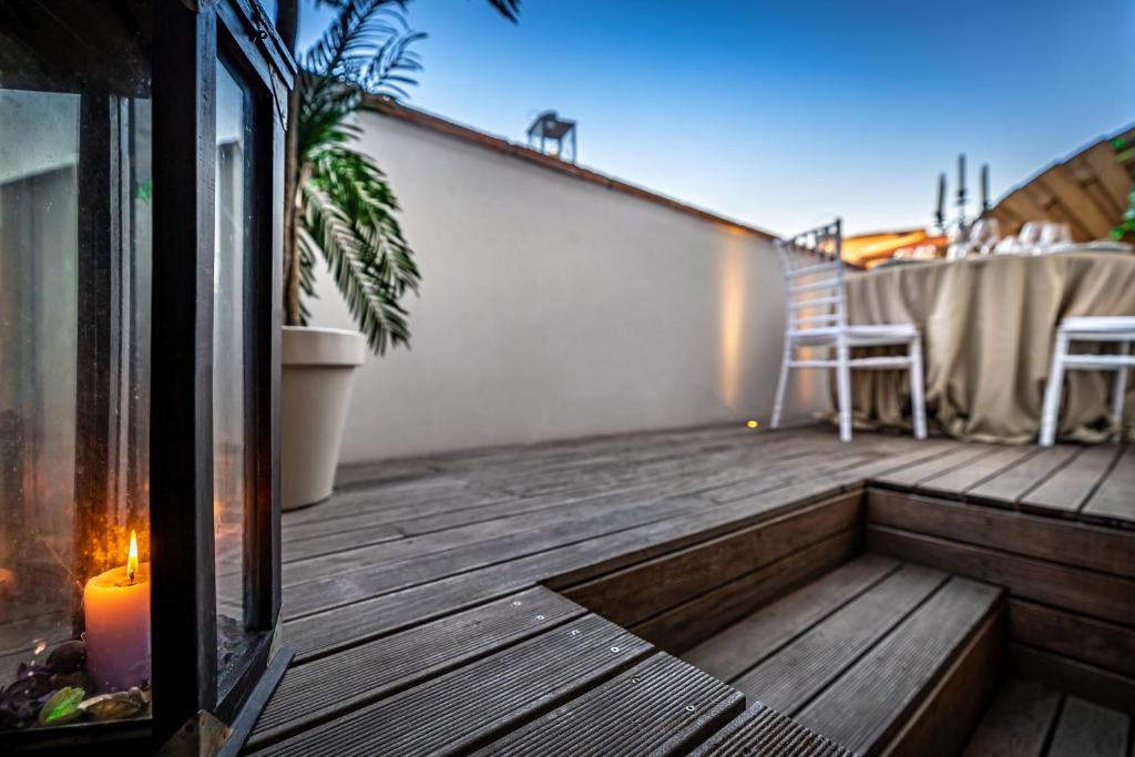 a deck with a candle and a chair on it at Palazzo dei Conti Residenza d'Epoca in Florence