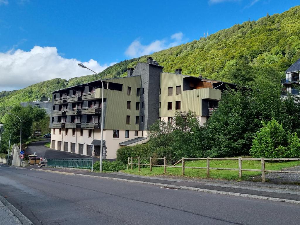 a building on the side of a hill at Appartement 1-4 personnes, Résidence "Le Belouga" in Le Mont-Dore