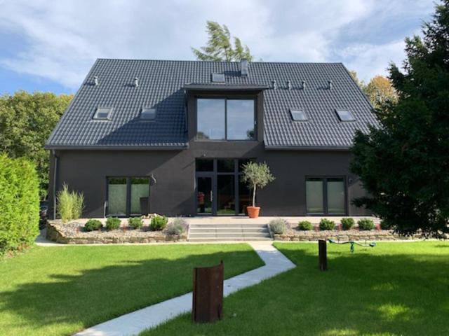 a large house with a yard with a house at Black House 88 in Ustroń