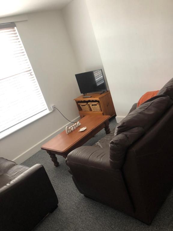 a living room with a couch and a table at The Borough apartment in Kent