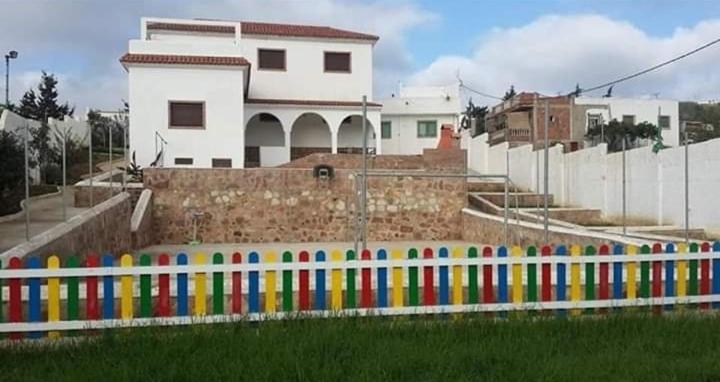 a colorful fence in front of a building at Villa Haidra in Dar Merah Deriba