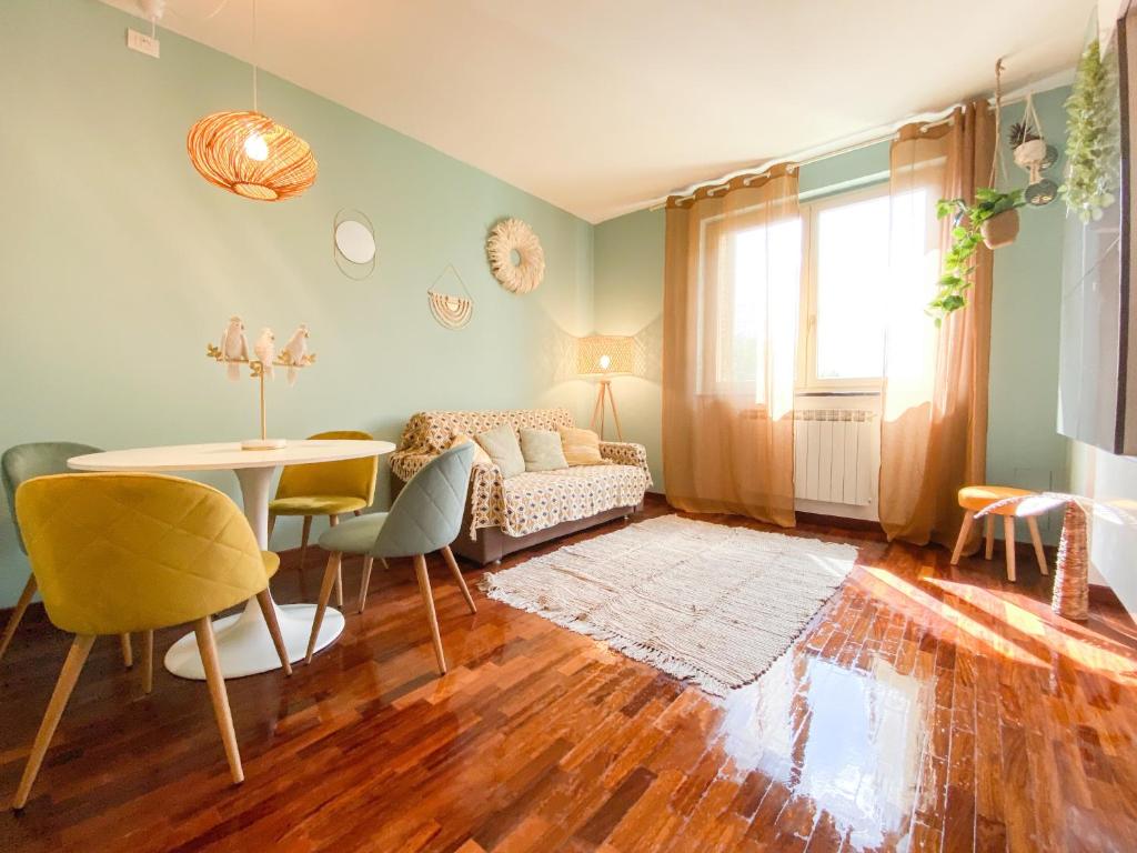 a living room with a couch and a table at GIALLOMANGO Apt in Lucca in Lucca