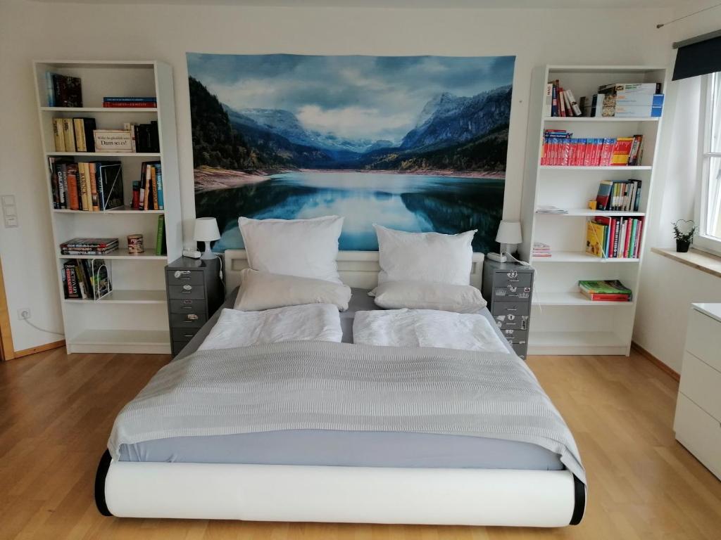 a bedroom with a bed with a painting on the wall at Tolles seenahes Apartment am Bodensee mit großer Terrasse in Sipplingen