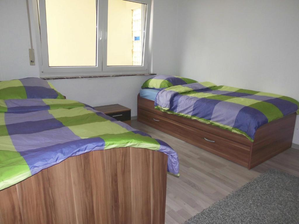 Ένα ή περισσότερα κρεβάτια σε δωμάτιο στο Frankfurt Airport & Fair Apartment