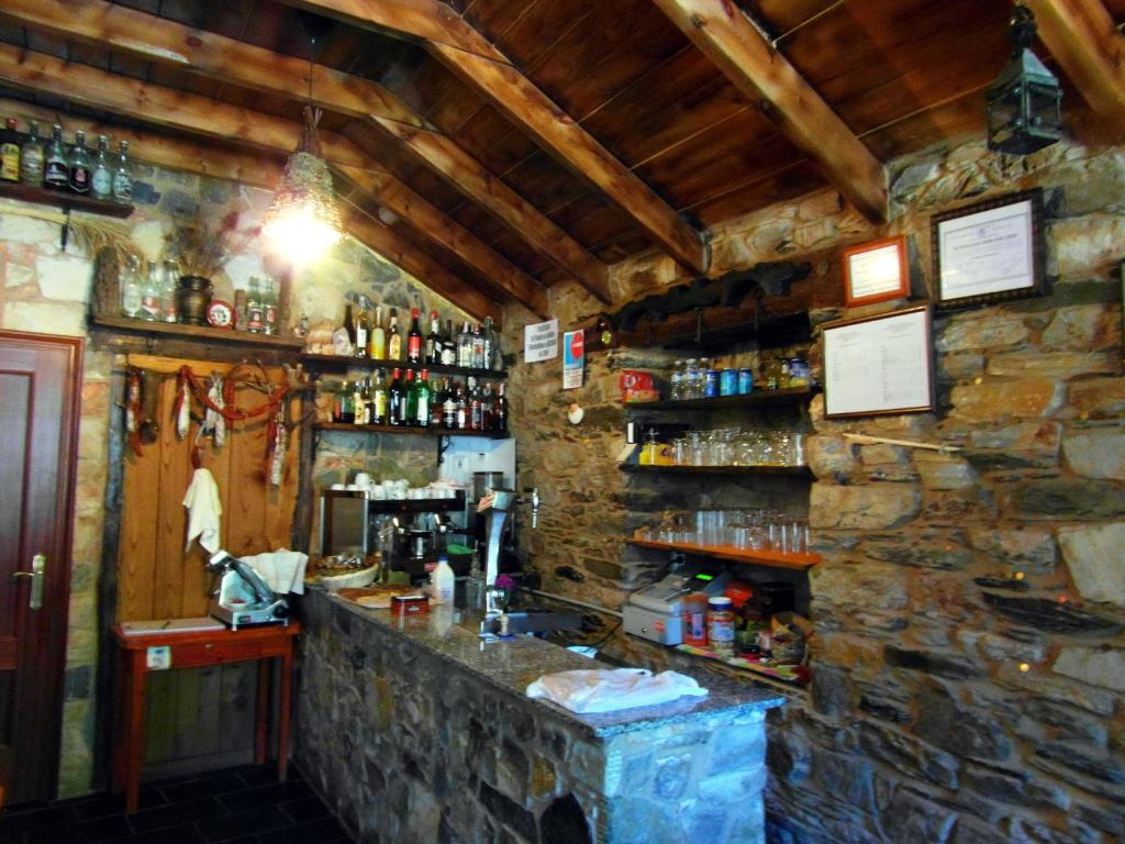 un bar en una habitación con una pared de piedra en Casa de Lucas en Fonfría