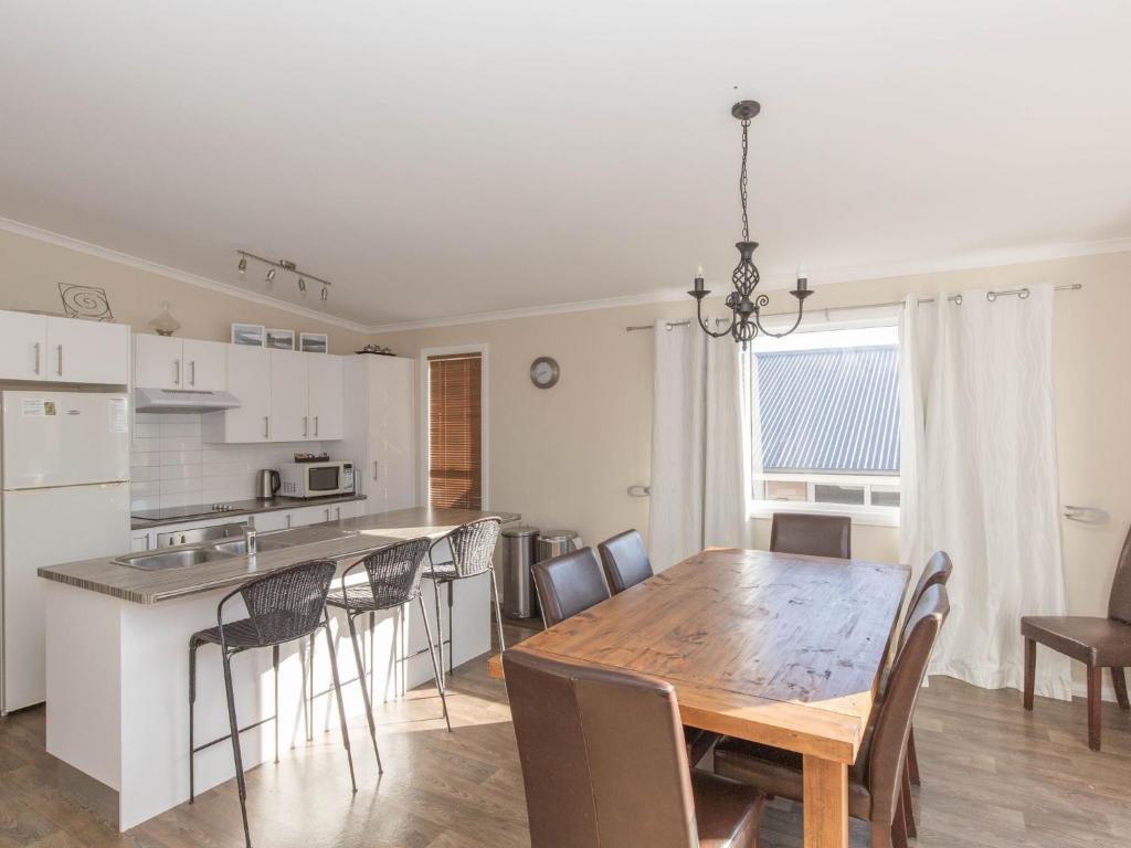 a kitchen and dining room with a table and chairs at St Helenas 5 Twynam Street in Jindabyne