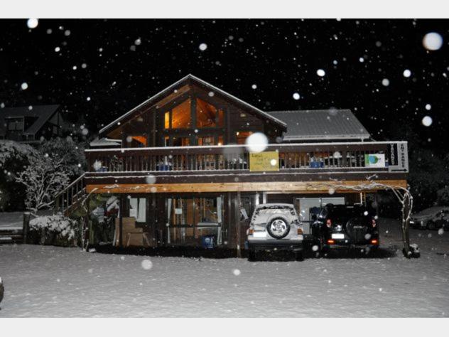 a house with a truck in front of it in the snow at Dakune Lodge in Ohakune