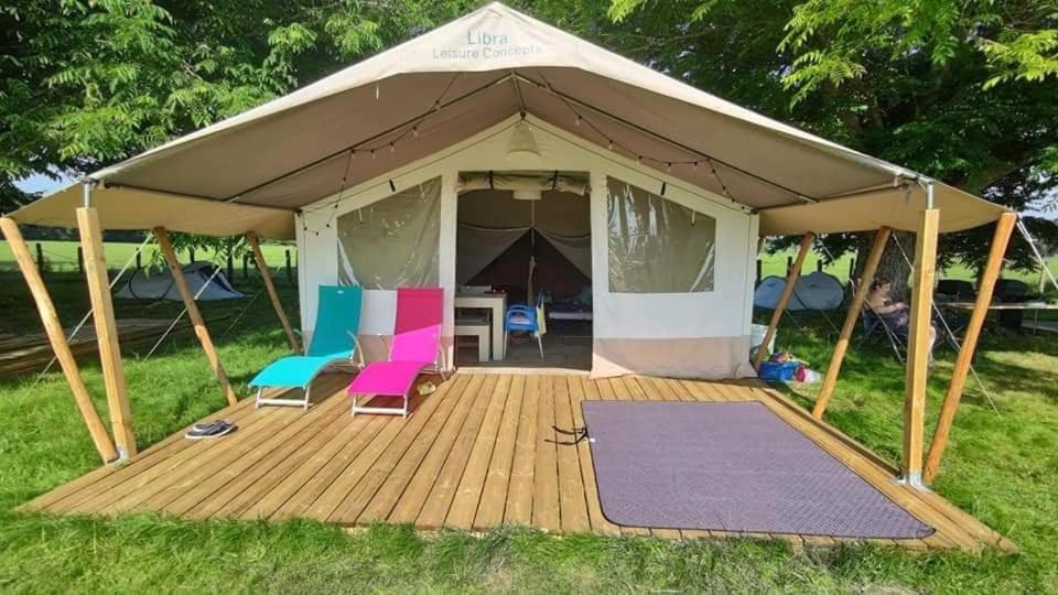 a gazebo with chairs and a table in it at TENTE LODGE la Plage AUTET in Autet