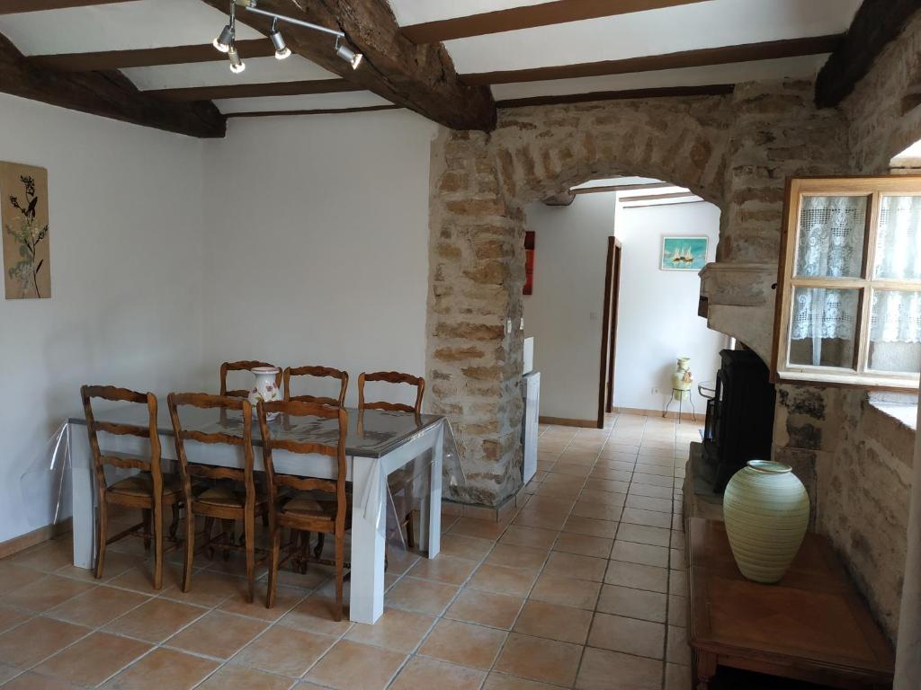a dining room with a table and chairs at GÎTE DU COLOMBIER in Vernoux