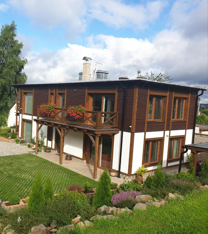 a large house with a balcony in a yard at Residence in Mariánské Lázně