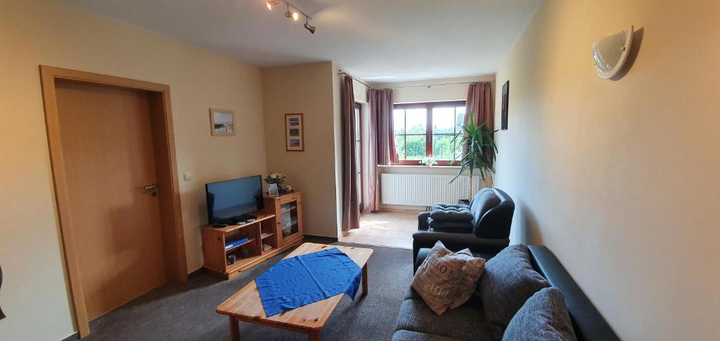 a living room with a couch and a tv at Ferienwohnung groß in Lütow