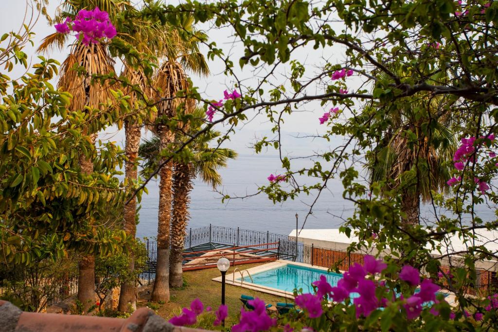 a resort with a swimming pool and a view of the ocean at Datca Villa Carla Hotel in Datca