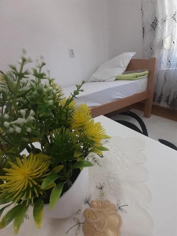a table with a vase of flowers on top of it at Bella apartment in Skopje
