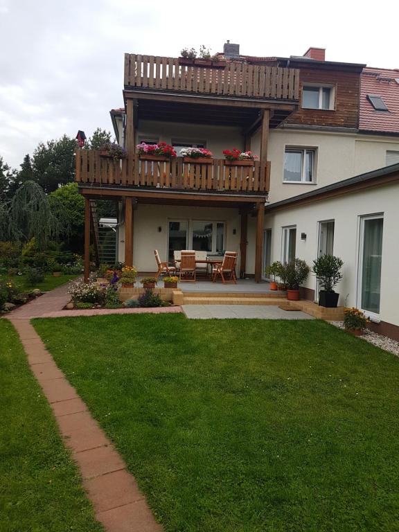 a house with a deck and a lawn at 70m² Zweiraumwohnung am Spreewaldradweg in Cottbus in Cottbus