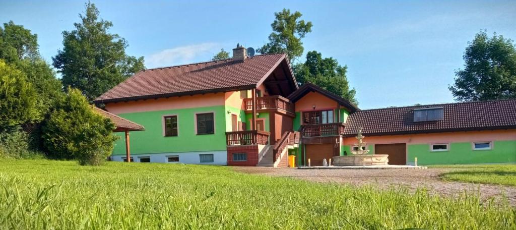 a large house with green and orange at Vila Bělá pod Pradědem in Bělá pod Pradědem