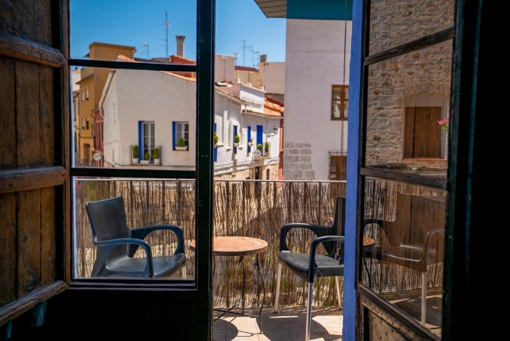 Habitación con vistas a un balcón con 2 sillas y una mesa. en DOMUS AMABILIS - ESPAI GAETA, en Sagunto