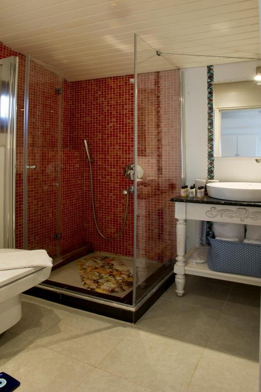 a bathroom with a shower and a sink at Lodos Butik Hotel in Alaçatı