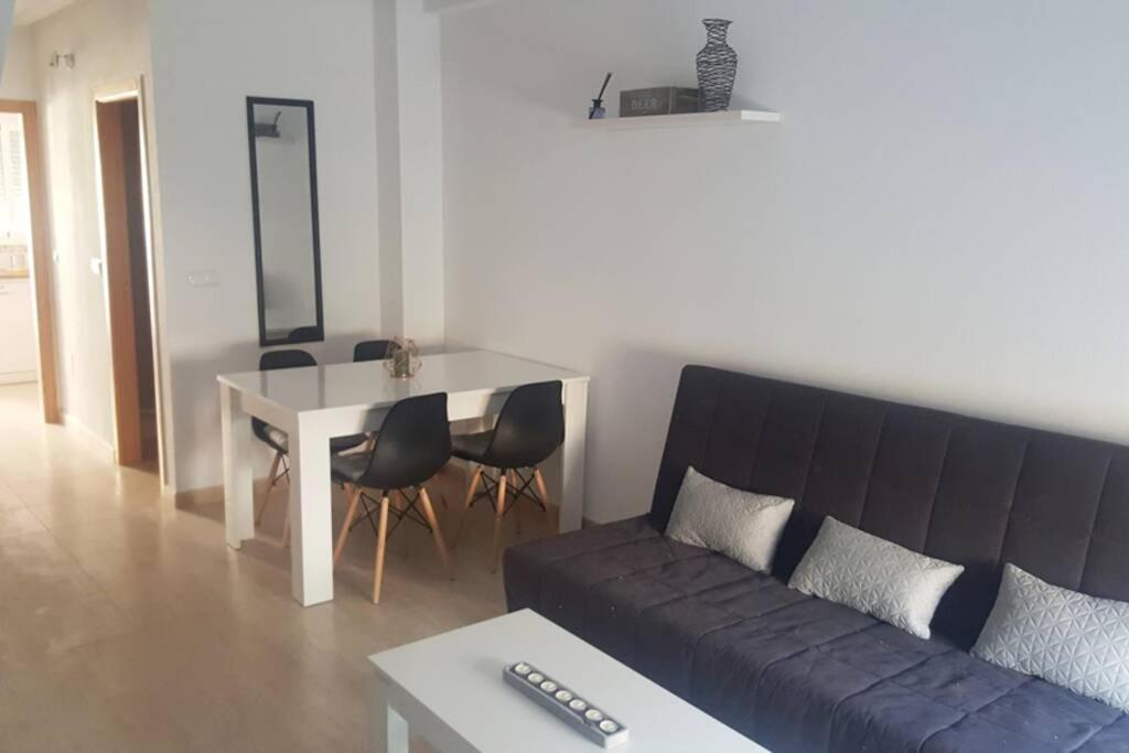 a living room with a couch and a table at Casa, sol y playa 365 días!! in San Juan de los Terreros