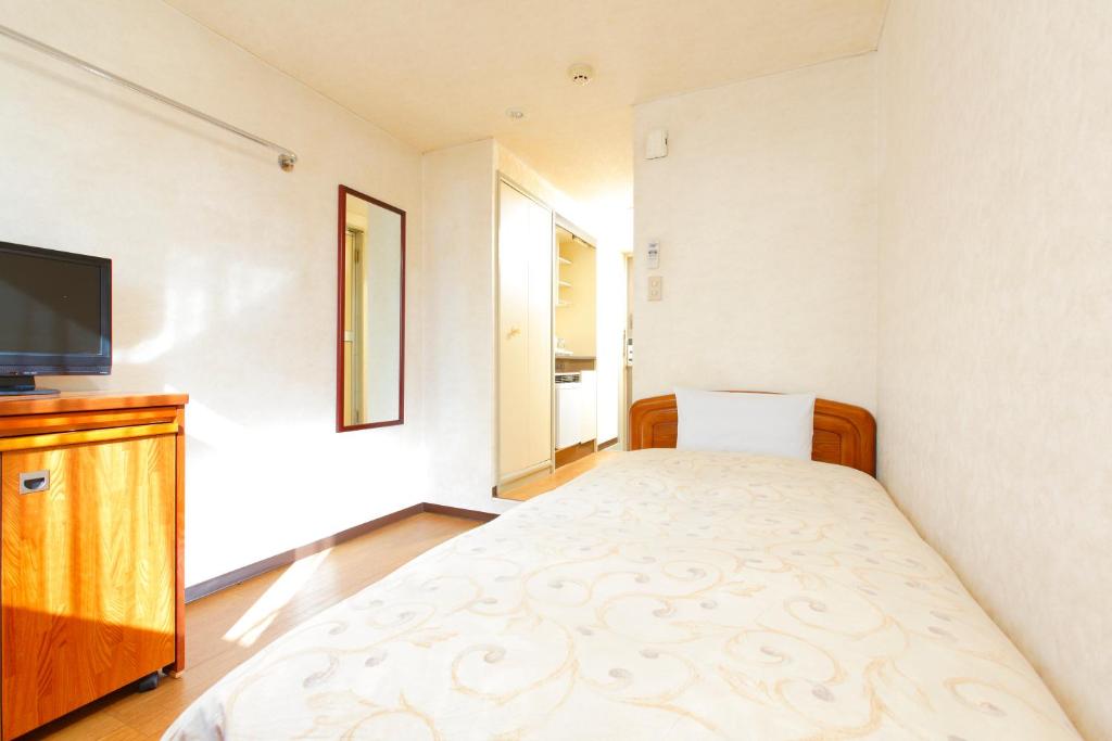 Postel nebo postele na pokoji v ubytování FLEXSTAY INN Nakanobu
