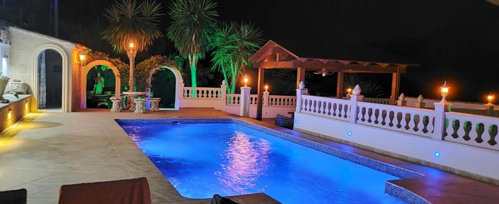 a swimming pool in a backyard at night at Villa med panoramautsikt med privat pool i Calpe, Costa Blanca, Spanien in Calpe
