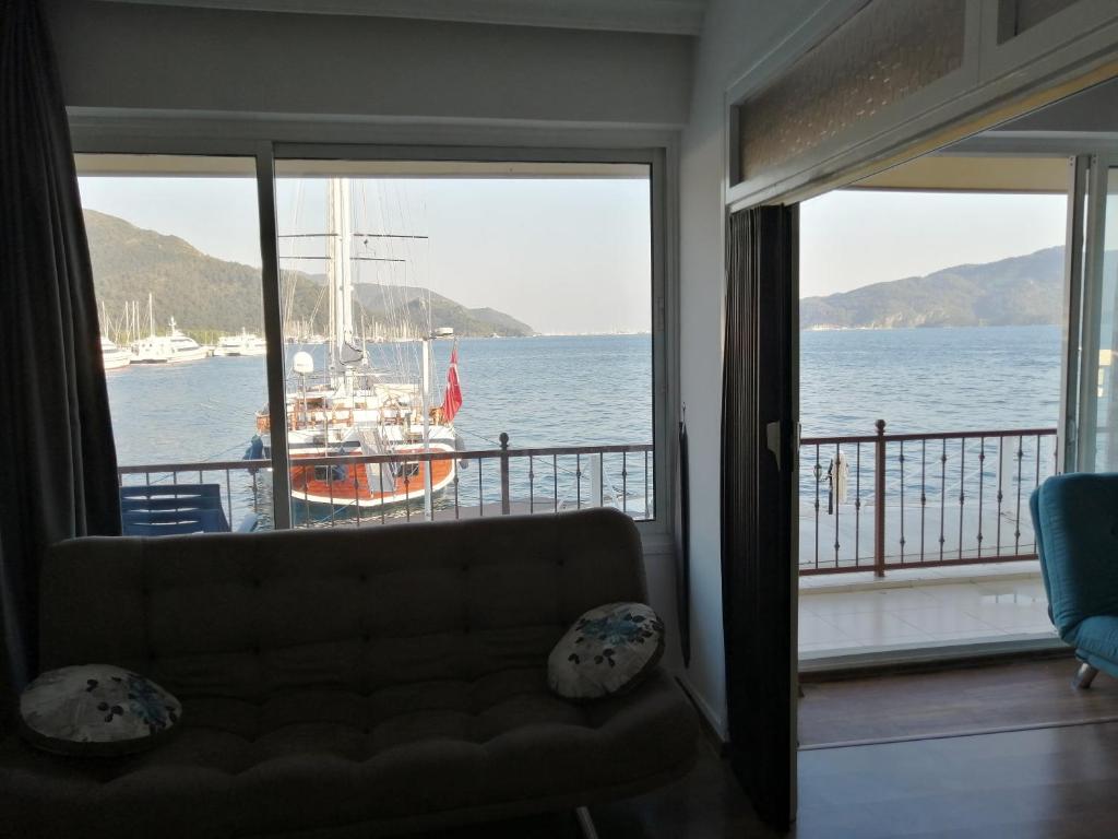 a living room with a couch and a view of the water at Uysal Suite and Loft Seaside in Marmaris