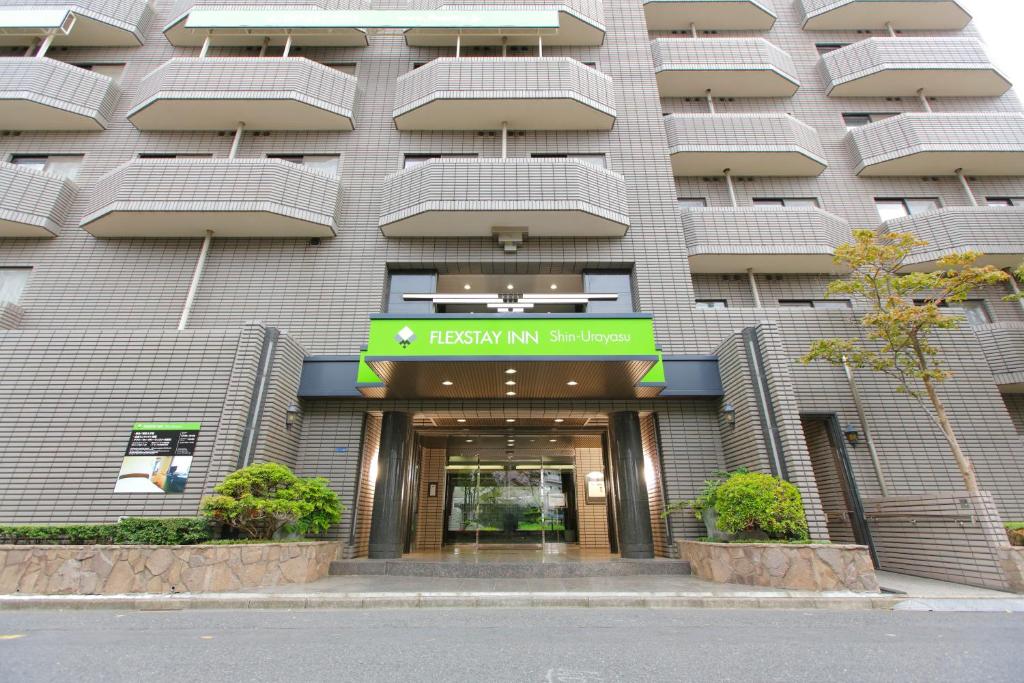 a hotel building with a sign in front of it at FLEXSTAY INN Shinurayasu in Urayasu