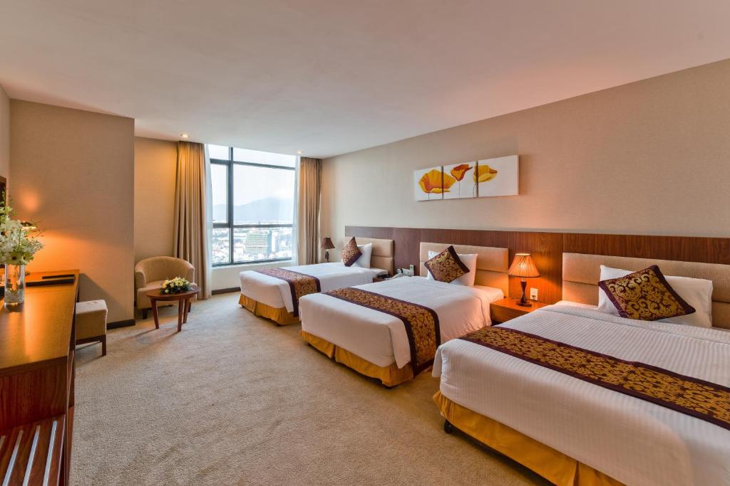 Postel nebo postele na pokoji v ubytování Muong Thanh Grand Da Nang Hotel