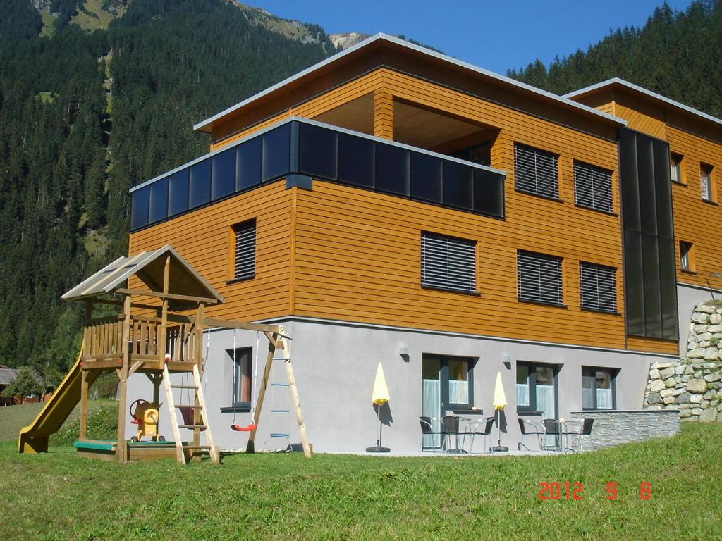 a large house with a playground in front of it at Haus Elisabeth in Gaschurn