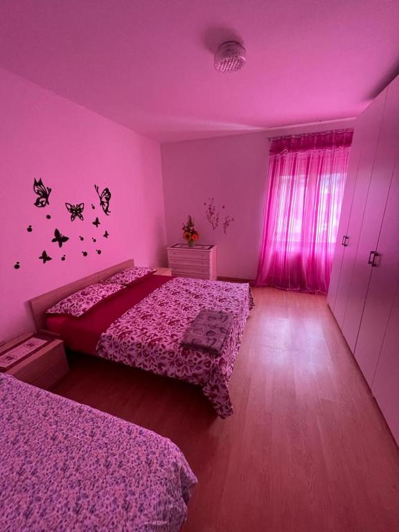 Łóżko lub łóżka w pokoju w obiekcie Palazzina Rosa