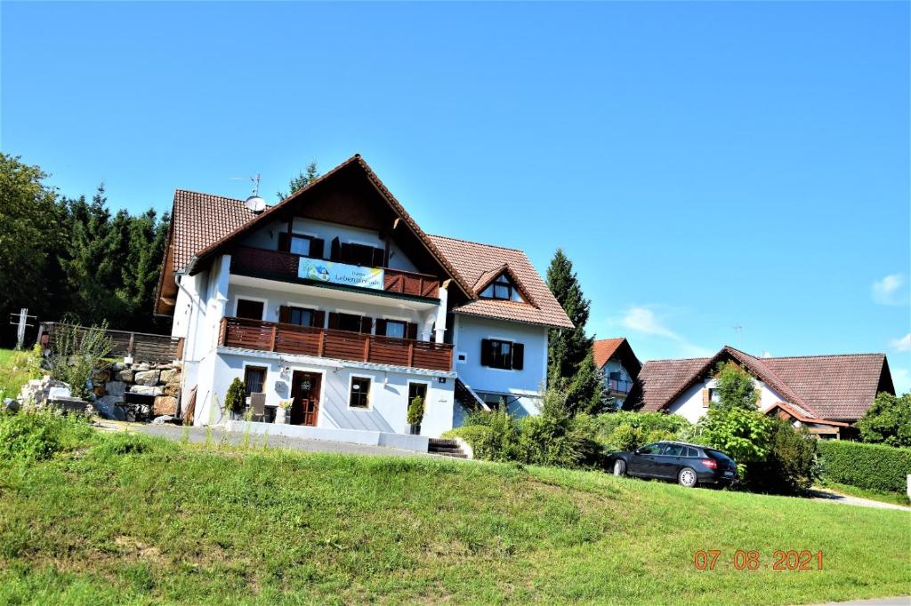 a house sitting on top of a green hill at Haus Lebensfreude in Magland