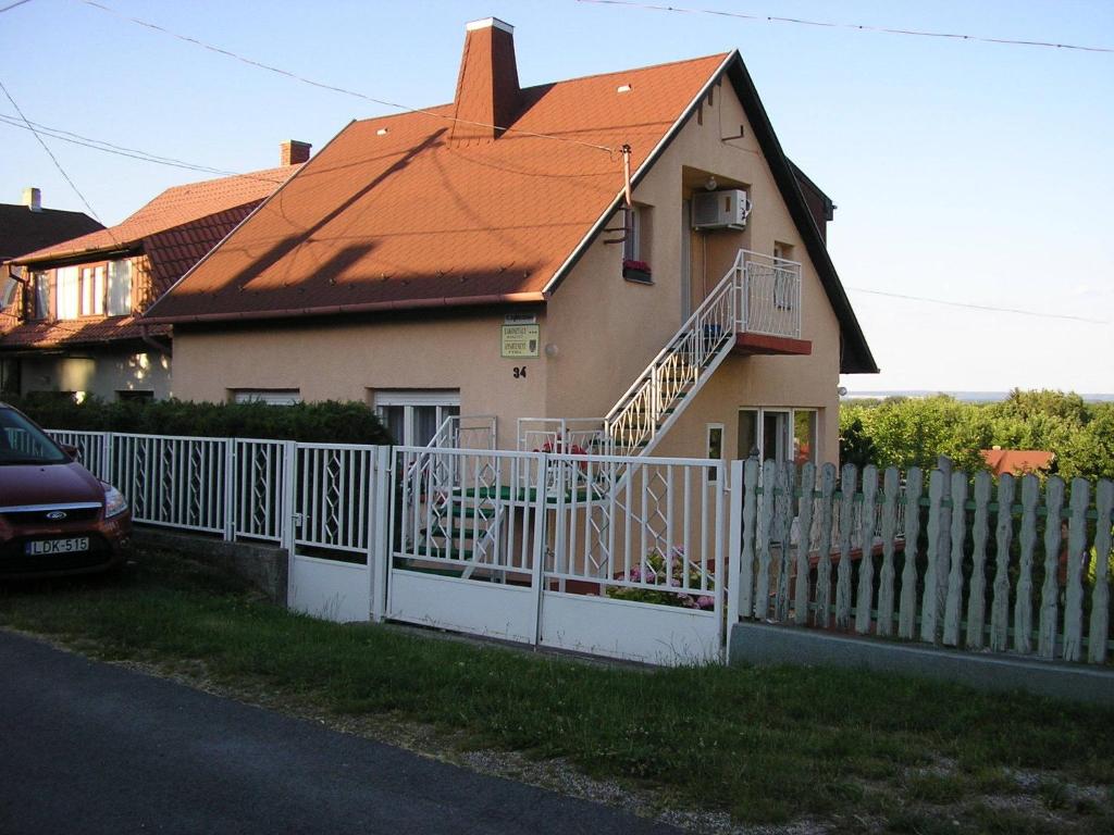 a house with a white fence in front of it at Ágnes Villa in Zalakaros